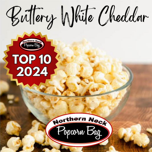 A bowl of buttery white cheddar popcorn with a label indicating 'Top 10 2024' and the brand 'Northern Neck Popcorn Bag'
