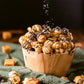 Caramel popcorn drizzled with dark chocolate and sea salt in a wooden bowl